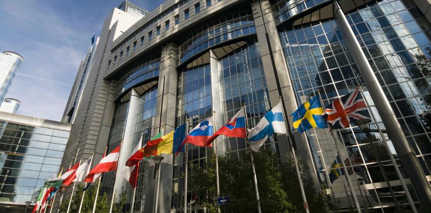 the flags of the European Union fly in front of a building