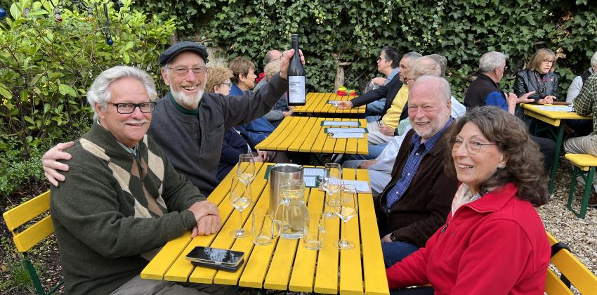 people sitting at table drinking wine