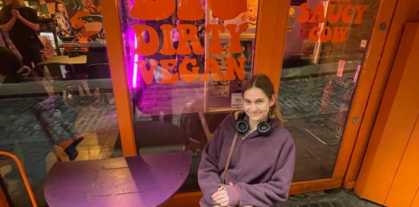 Outside of The Saucy Cow, the window sign says Big, Dirty, Vegan