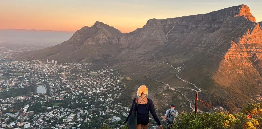Image atop Lions Head Mountain looking at Table mountain and Devils Peak as the sun sets. 