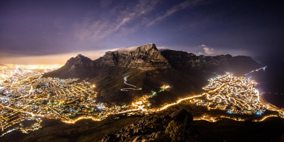 a nighttime aerial view of Cape Town and its mountains