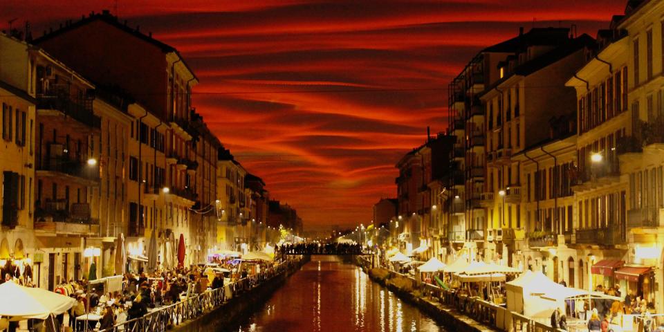 a stunning shot of a canal in Milan just after sunset