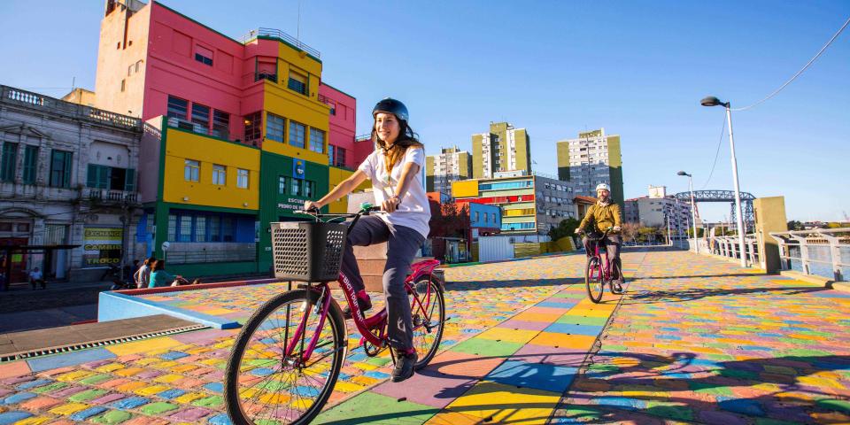student riding bike in colorful street of Buenos Aires