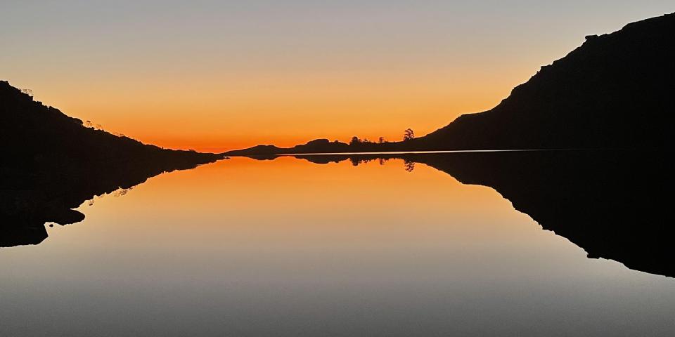 Sun setting over a body of water. 