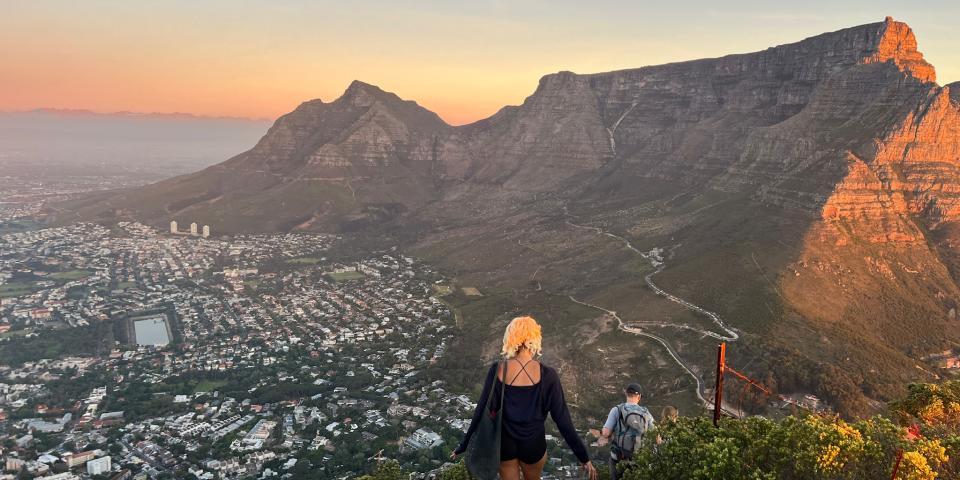 Image atop Lions Head Mountain looking at Table mountain and Devils Peak as the sun sets. 